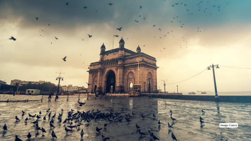 Gateway of India with birds flying in the early morning sky