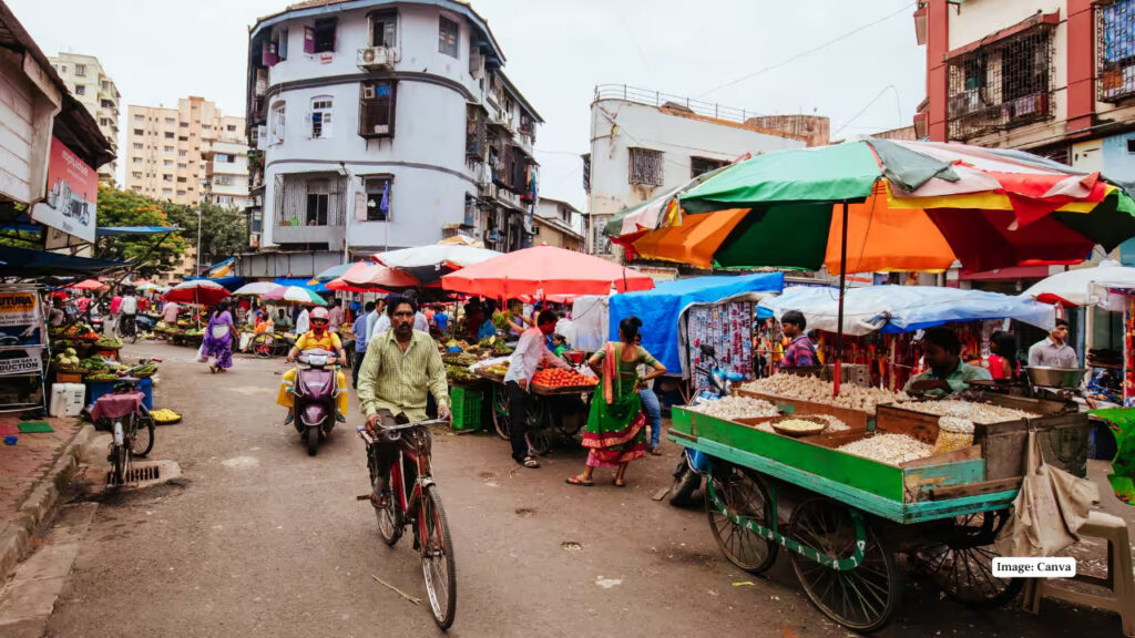 Busy street scene at Colaba Causeway with shops and people shopping