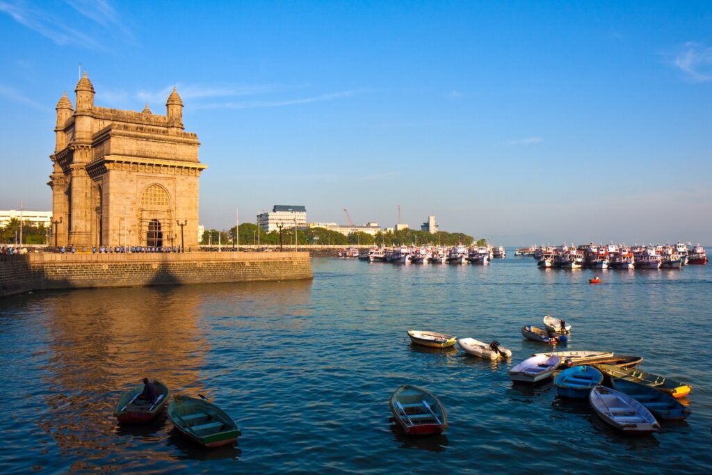 Gateway of India and Taj Mahal Palace Hotel in Mumbai with ferries at the waterfront — Travel content by Ajjay Bhagyakar.