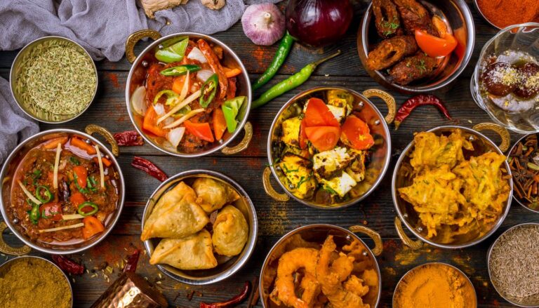 Traditional Mumbai street food platter with samosas, pakoras, curries, and chutneys